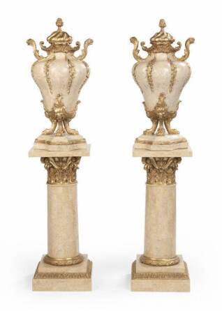 EVANDER HOLYFIELD MARBLE AND PARCEL GILT EMPIRE STYLE VASES ON MARBLE COLUMNS