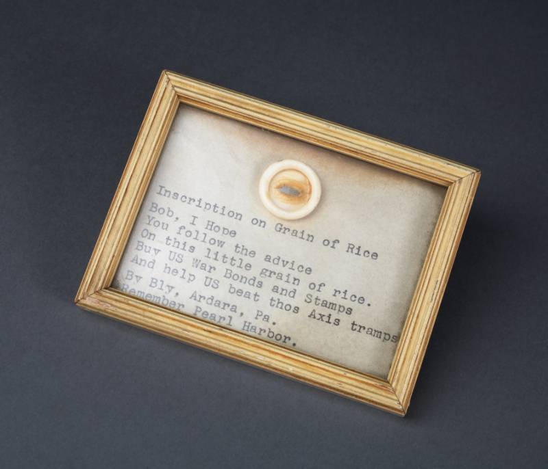 GRAIN OF RICE WITH WAR BOND INSCRIPTION