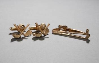 A SET OF GOLF-THEMED CUFF LINKS AND A TIE PIN