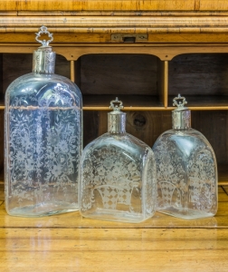 LUISE RAINER GROUP OF THREE ETCHED GLASS DECANTERS