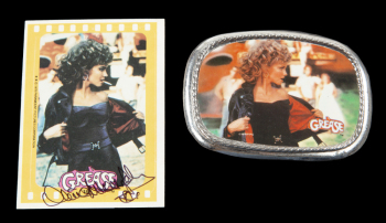 OLIVIA NEWTON-JOHN GREASE BELT BUCKLE, SIGNED TRADING CARD AND SIGNED IMAGES
