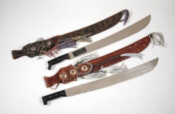 TWO MACHETE SWORDS WITH DECORATIVE LEATHER SHEATHS