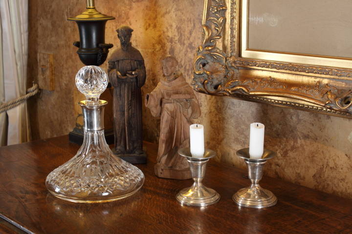 TWO CARVED WOODEN SANTOS STATUETTES, DECANTER AND CANDLESTICKS