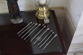 GOUP OF NINE ASSORTED ARGENTINE COCOA STIRRERS AND A LADLE