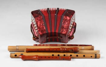 GROUP OF EIGHT WOODEN FLUTES AND AN ITALIAN ACCORDION