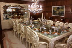 A MODERN ITALIAN DINING ROOM SET FOR FOURTEEN