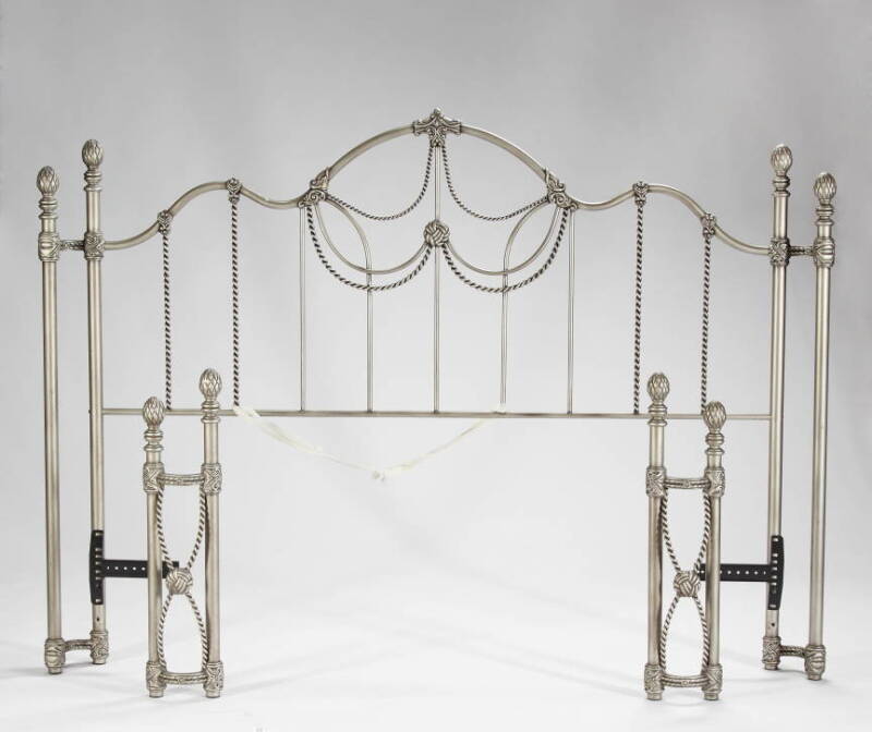 A PATINATED METAL BED FRAME