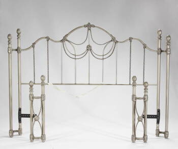 A PATINATED METAL BED FRAME