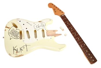 NIRVANA | KURT COBAIN STAGE-PLAYED AND SMASHED BAND-SIGNED FENDER STRATOCASTER ELECTRIC GUITAR (WITH PHOTOS)
