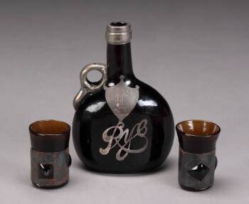 AN AMBER GLASS DECANTER SET