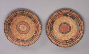 A SET OF TWO POLYCHROME NIGERIAN BASKETS