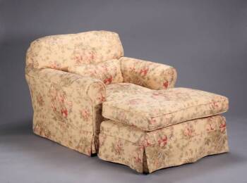 A UPHOLSTERED CLUB CHAIR WITH MATCHING OTTOMAN