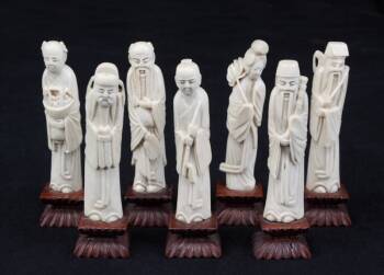 A GROUP OF SEVEN CHINESE IVORY IMMORTAL FIGURINES