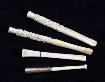 A GROUP OF FOUR IVORY CIGARETTE HOLDERS