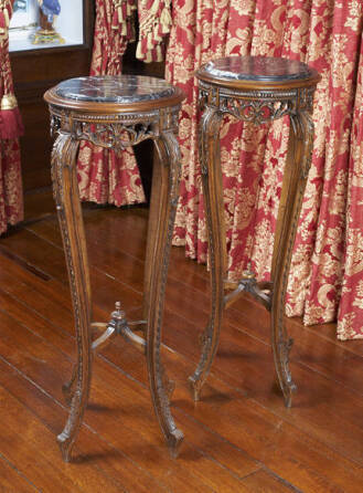 A PAIR OF CARVED STAINED BEECH TORCHERES