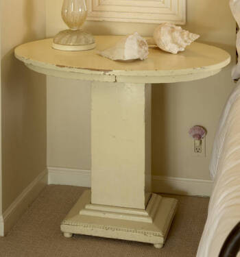 A SIDE TABLE WITH OVAL TOP AND RECTANGULAR PEDEST