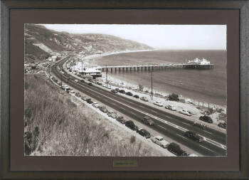 A FRAMED REPRODUCTION PHOTOGRAPH OF THE MALIBU PI