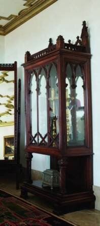 CHER - A GOTHIC STYLE WALNUT CABINET ON STAND