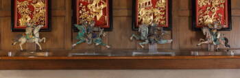 A GROUP OF SEVEN CHINESE ROOF TILE STATUETTES TOGETHER WITH A PAIR OF DRUM TABLES